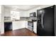 Modern kitchen features stainless steel appliances, white cabinets, hardwood floors and a unique backsplash at 2201 Schoolmarm Dr, Greenfield, IN 46140