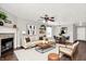 Bright living room with modern decor, fireplace, ceiling fan, and dark wood floors at 2201 Schoolmarm Dr, Greenfield, IN 46140