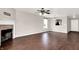 Spacious living room featuring a fireplace, ceiling fan, hardwood floors, and lots of natural light at 2201 Schoolmarm Dr, Greenfield, IN 46140