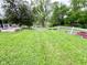 This backyard has a lush, green lawn and a white fence, offering a serene outdoor space at 2221 E 35Th St, Anderson, IN 46013
