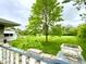 View of the backyard featuring a large grassy area, a mature shade tree, and a concrete patio at 2221 E 35Th St, Anderson, IN 46013