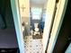 Bathroom featuring a toilet, sink, patterned floors, and tiled walls at 2221 E 35Th St, Anderson, IN 46013