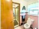 Bathroom featuring a tiled shower, patterned floors, pink tiled walls, and a window at 2221 E 35Th St, Anderson, IN 46013