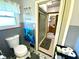 Bathroom featuring a toilet, tiled walls, and view into the shower at 2221 E 35Th St, Anderson, IN 46013