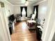 Bright bedroom with hardwood floors, two windows, dark curtains, and a ceiling fan at 2221 E 35Th St, Anderson, IN 46013