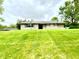 Charming single-story home on a well-manicured, sloping front lawn at 2221 E 35Th St, Anderson, IN 46013