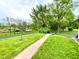 Lush front yard with a paved walkway, mature trees, and green space at 2221 E 35Th St, Anderson, IN 46013
