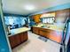 Kitchen featuring wood cabinets, light countertops, and a view into the dining area at 2221 E 35Th St, Anderson, IN 46013