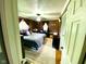 Cozy main bedroom featuring dark walls, hardwood floors, ceiling fan and a comfortable-looking bed at 2221 E 35Th St, Anderson, IN 46013