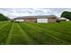 Brick home's backyard featuring a green lawn and a privacy fence in a well-maintained community at 2508 Pamela Ct, Anderson, IN 46012