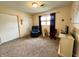 Spacious bedroom with natural light, a cozy blue chair, a closet and dark colored curtains at 2508 Pamela Ct, Anderson, IN 46012