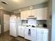 Kitchen featuring white appliances and cabinetry, providing a clean and functional cooking space at 2508 Pamela Ct, Anderson, IN 46012
