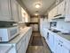 Well-lit kitchen features white cabinetry, appliances, and includes a washer and dryer for added convenience at 2508 Pamela Ct, Anderson, IN 46012