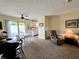 Inviting living room featuring a sliding glass door to the patio, comfortable seating, and a view of the kitchen at 2508 Pamela Ct, Anderson, IN 46012