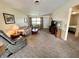 Spacious living room featuring neutral carpeting, comfortable seating, and natural light from the window at 2508 Pamela Ct, Anderson, IN 46012