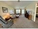 Spacious living room featuring neutral carpeting, comfortable seating, and natural light from the window at 2508 Pamela Ct, Anderson, IN 46012