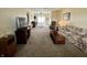 Spacious living room featuring neutral carpeting, comfortable seating, and natural light from the window at 2508 Pamela Ct, Anderson, IN 46012