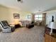 Cozy living room featuring neutral carpeting, comfortable seating, and natural light from the window at 2508 Pamela Ct, Anderson, IN 46012
