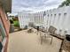 Cozy outdoor patio with white picket fence, seating, and a small table for relaxing and enjoying the fresh air at 2508 Pamela Ct, Anderson, IN 46012