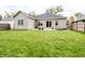 Large green backyard with patio, tan siding, new windows and a lush green lawn at 2686 Lafayette Ave, Columbus, IN 47201