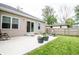 Spacious backyard patio area with chair, plantings, and direct access to the home at 2686 Lafayette Ave, Columbus, IN 47201