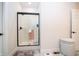 Bright bathroom featuring a glass-enclosed shower with white tiling and modern fixtures and a woven laundry hamper at 2686 Lafayette Ave, Columbus, IN 47201