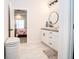 Bathroom with dual sinks, white cabinets, and a view into the primary bedroom at 2686 Lafayette Ave, Columbus, IN 47201