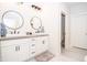 Bathroom featuring double sinks, modern lighting fixtures, and tile flooring at 2686 Lafayette Ave, Columbus, IN 47201