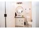 Half bathroom featuring modern sink, vanity, black mirror, toilet, and modern light fixture at 2686 Lafayette Ave, Columbus, IN 47201