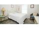 Cozy bedroom with white metal bed frame, window, and glass side table on neutral carpeting at 2686 Lafayette Ave, Columbus, IN 47201