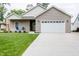 Charming single-story home featuring a well-manicured lawn and a two-car garage at 2686 Lafayette Ave, Columbus, IN 47201