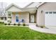 Close-up of charming front porch with seating and manicured landscaping at 2686 Lafayette Ave, Columbus, IN 47201