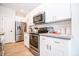 Well-equipped kitchen featuring stainless steel appliances, white cabinetry, and sleek countertops at 2686 Lafayette Ave, Columbus, IN 47201