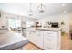 Open-concept kitchen view showcasing the island with modern fixtures, dining area, and living room at 2686 Lafayette Ave, Columbus, IN 47201