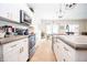Bright kitchen featuring white cabinets, stainless steel appliances, and a large island with sink at 2686 Lafayette Ave, Columbus, IN 47201