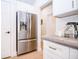 Close-up of the kitchen showcasing stainless steel refrigerator and white cabinetry at 2686 Lafayette Ave, Columbus, IN 47201