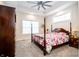 Comfortable main bedroom with a four-poster bed, ceiling fan, and natural light at 2686 Lafayette Ave, Columbus, IN 47201