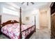 Inviting bedroom showcasing a four-poster bed and a view into an ensuite bathroom at 2686 Lafayette Ave, Columbus, IN 47201