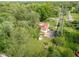 Aerial view shows the property with an outbuilding, lush greenery, and overhead powerlines at 2929 E 62Nd St, Indianapolis, IN 46220