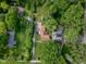 A high aerial view displays several properties surrounded by lush trees and powerlines at 2929 E 62Nd St, Indianapolis, IN 46220
