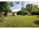 Spacious backyard with lush green lawn, a shed, and mature trees, offering ample space for outdoor activities at 2929 E 62Nd St, Indianapolis, IN 46220