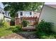 Backyard features a wooden pergola and deck, a brick patio, and mature trees at 2929 E 62Nd St, Indianapolis, IN 46220