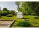 Backyard view featuring a shed, brick patio, green lawn, and luscious shrubs at 2929 E 62Nd St, Indianapolis, IN 46220