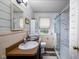 Bathroom with a sink, toilet, window, shower and white marble tile at 2929 E 62Nd St, Indianapolis, IN 46220