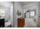 Open bedroom featuring a bathroom and stairs to another room at 2929 E 62Nd St, Indianapolis, IN 46220