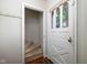 Inviting entryway with a white door, staircase, and hooks for coats at 2929 E 62Nd St, Indianapolis, IN 46220