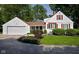 Charming home featuring a well-maintained lawn, red shuttered windows, and attached two car garage at 2929 E 62Nd St, Indianapolis, IN 46220