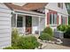 Inviting front porch area with seating, trimmed bushes, and direct access to the front entrance at 2929 E 62Nd St, Indianapolis, IN 46220