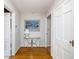 Hallway with hardwood floors, neutral walls, and a decorative table adding charm to the home's interior at 2929 E 62Nd St, Indianapolis, IN 46220