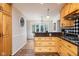 Kitchen area with wooden cabinetry, stainless gas cooktop, tile floors, and a peek into the adjacent breakfast nook at 2929 E 62Nd St, Indianapolis, IN 46220